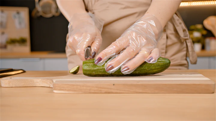 Cutting cucumber with eco gloves
